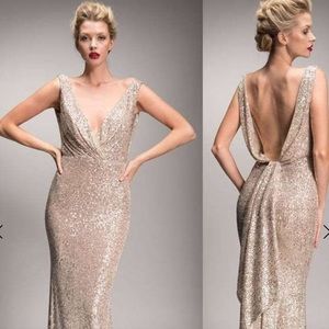 Nicole Bakti silver gown with open back. This dress has plenty of stretch!
